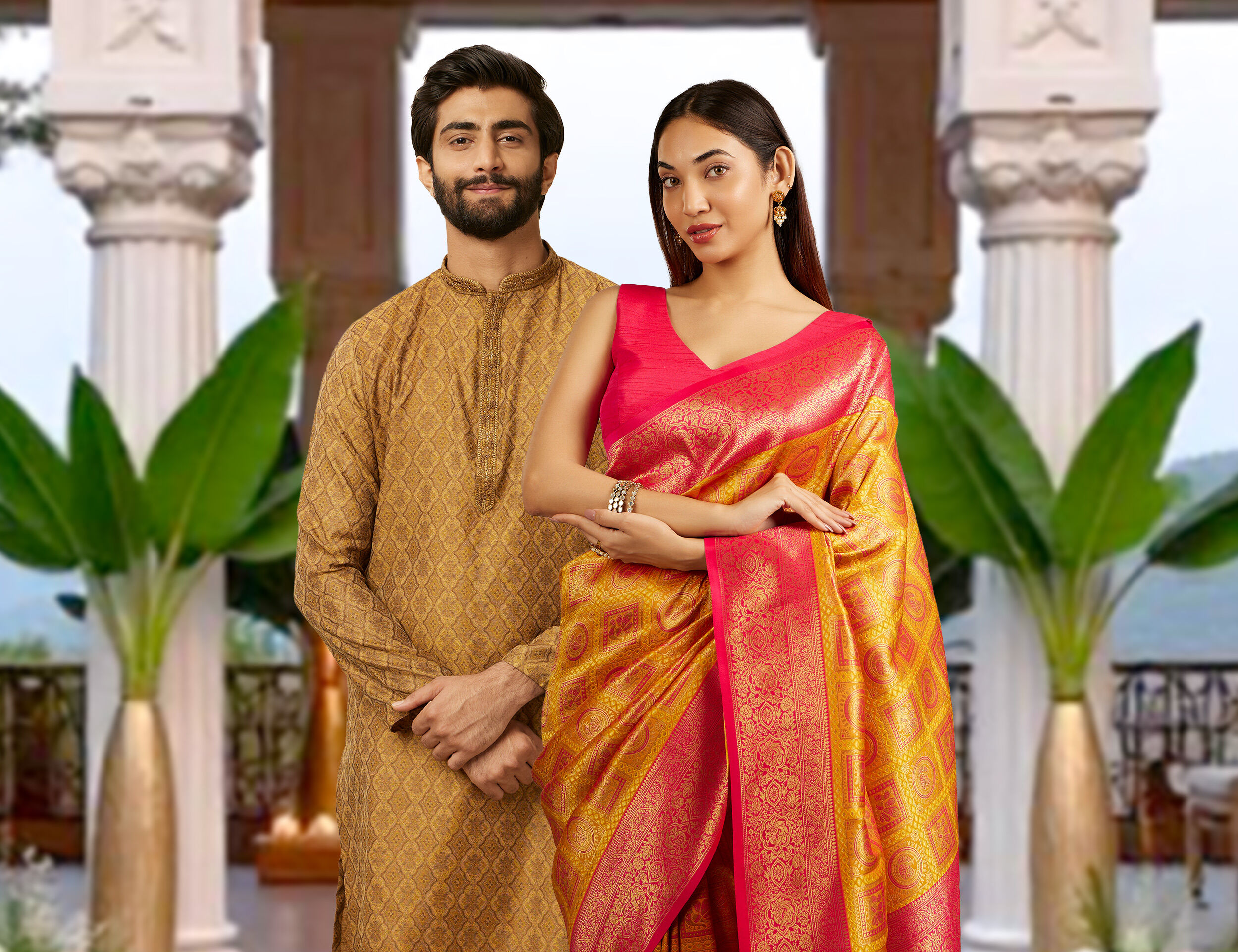 Man in a golden kurta and woman in a vibrant pink and gold saree, dressed in traditional Indian attire for Gudi Padwa and Ugadi celebrations, posing in an elegant setting