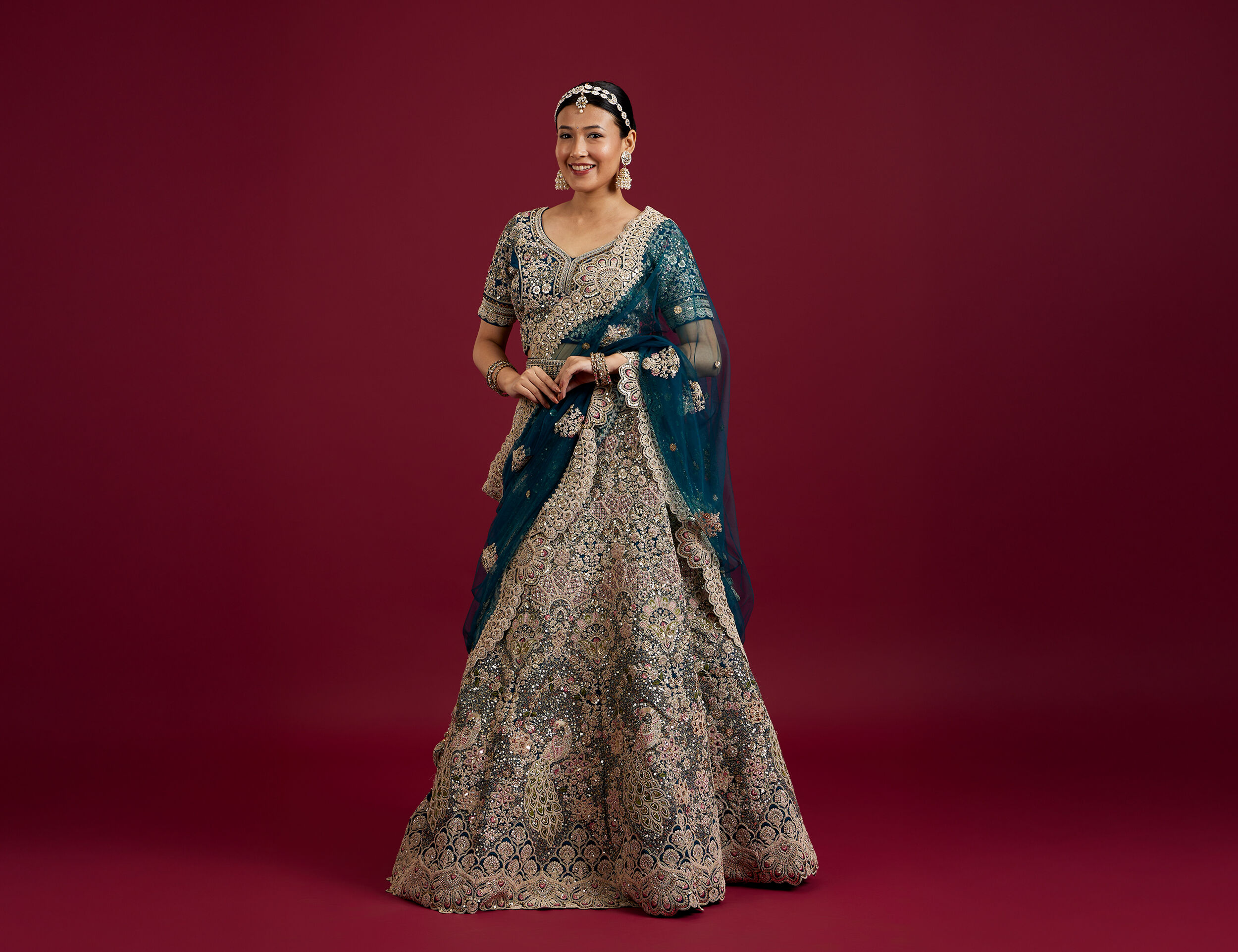 A women wearing beautifull blue lehenga with blue dupatta