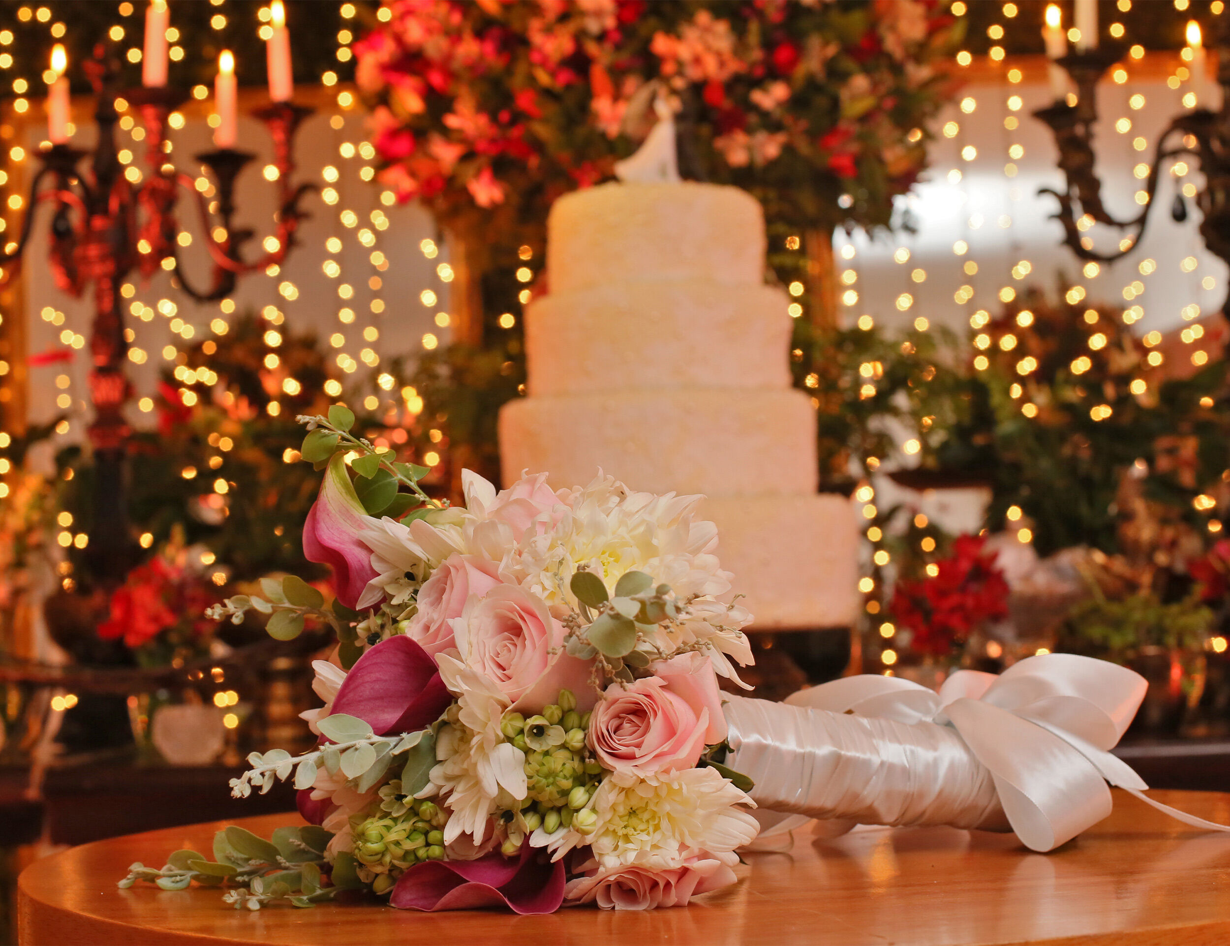 A beautifully decorated wedding reception table featuring elegant lanterns and floral accents