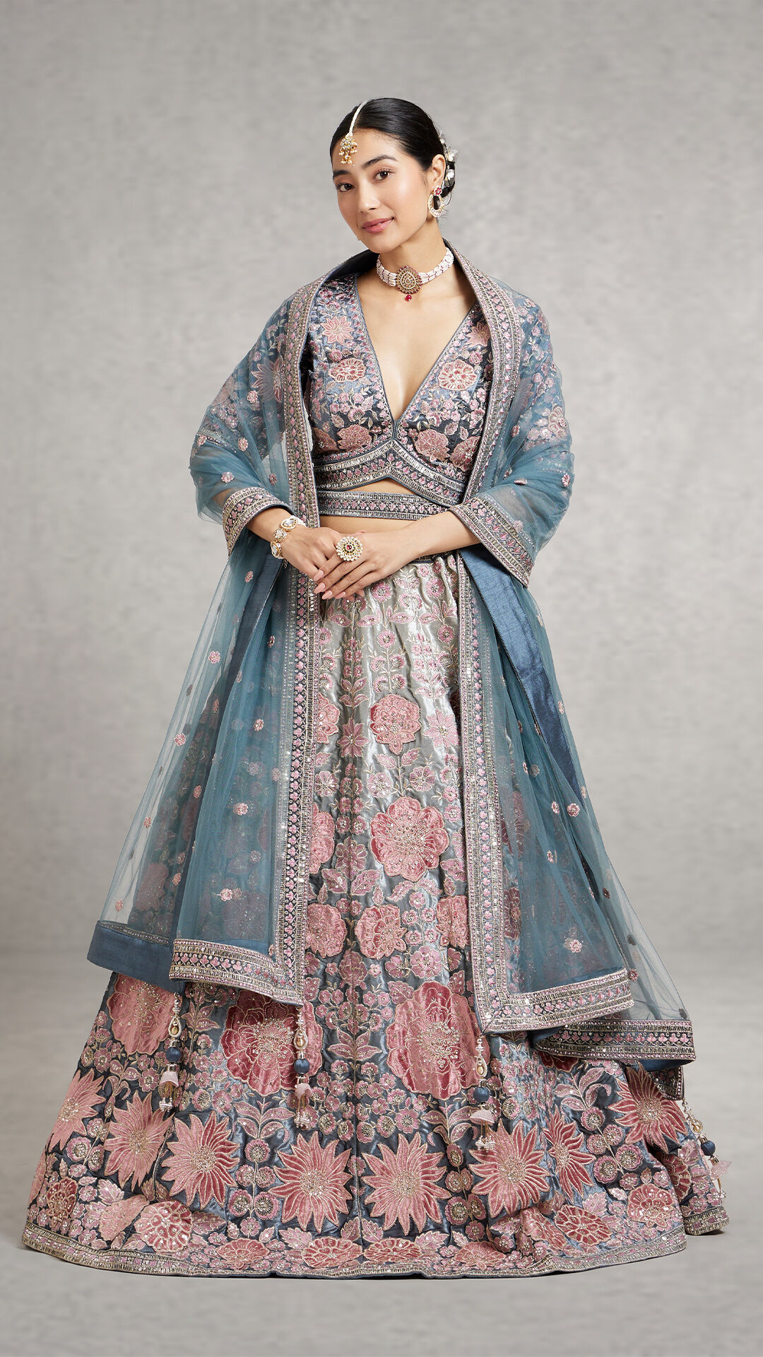 A women in beautifull  pink lehenga with blue dupatta 