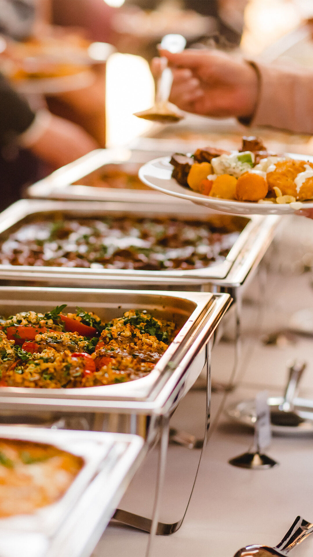 A man filling indian food from wedding buffet in indian wedding