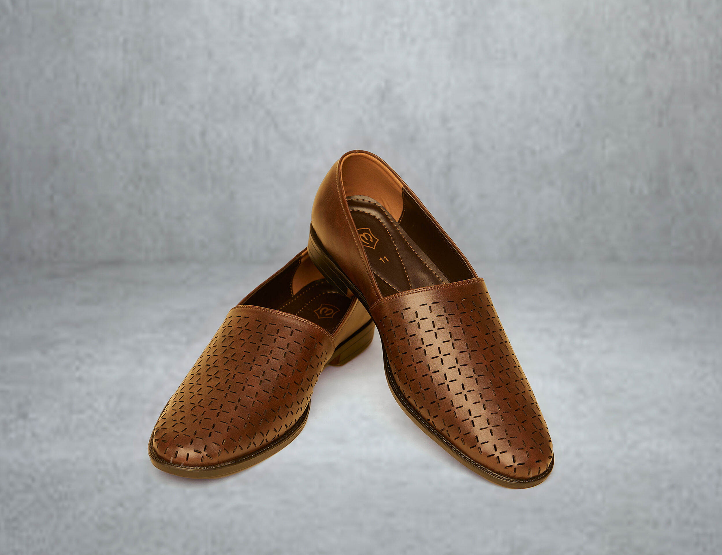 A brown pateern juttis for wedding