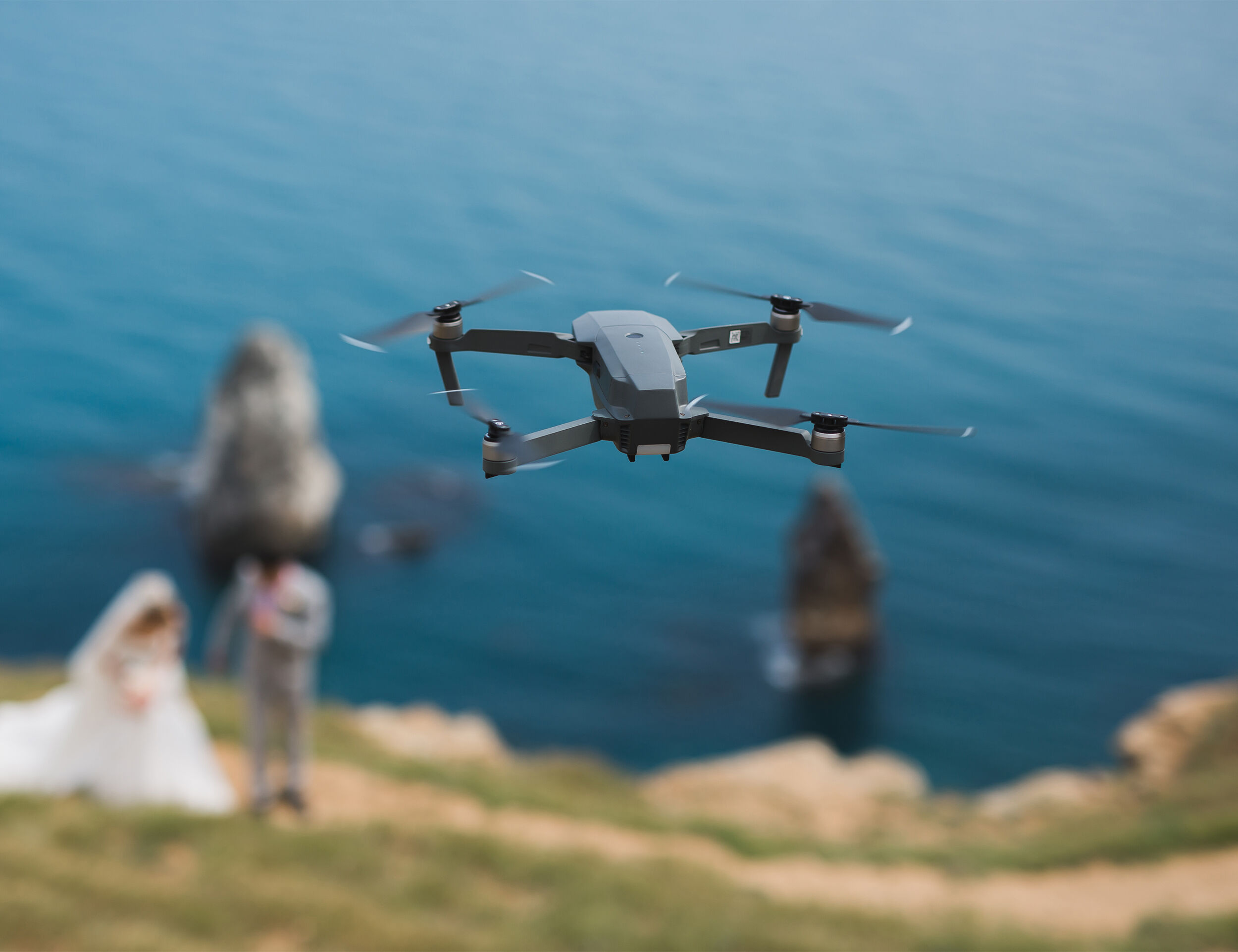 A drone filming bride and groom from skies