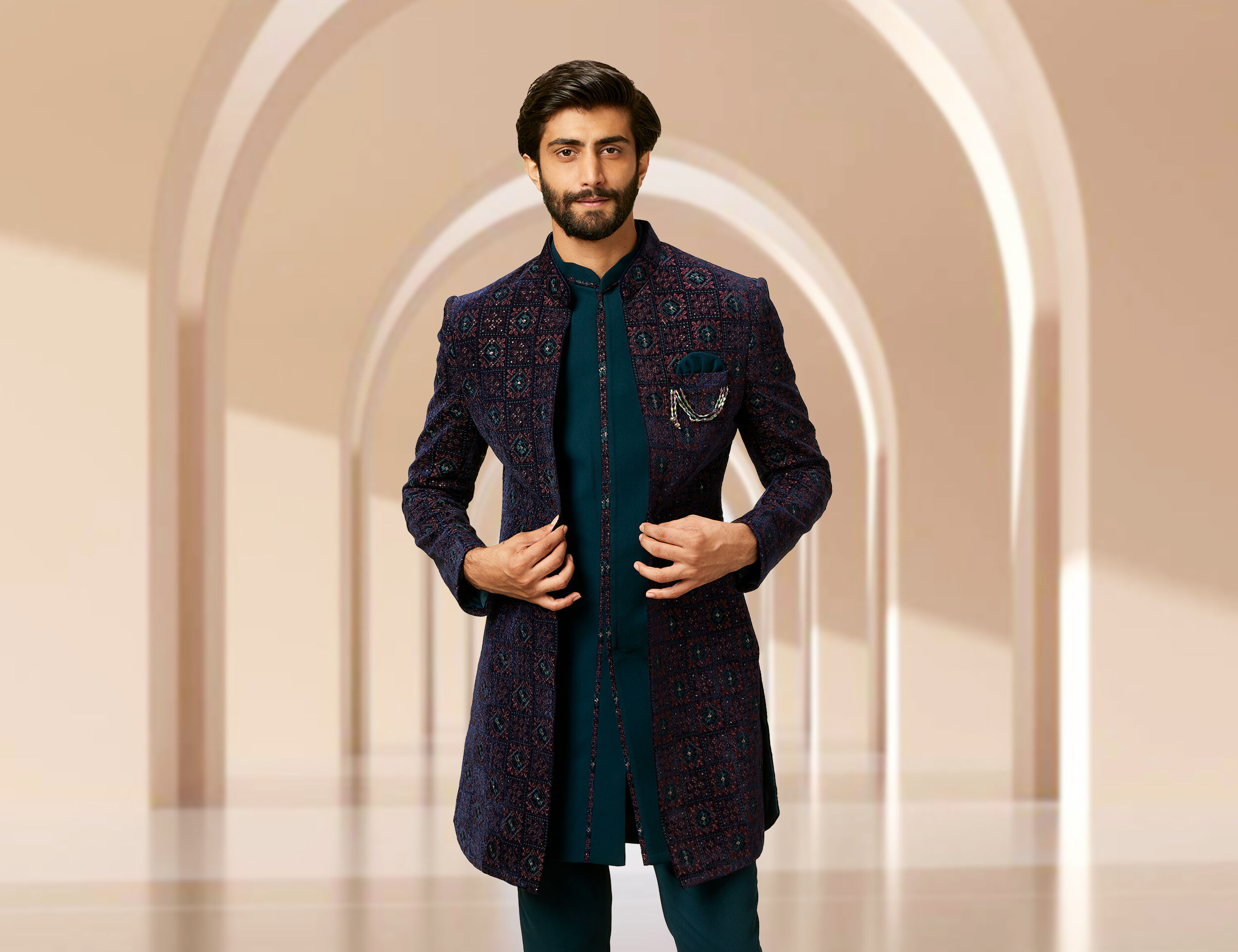 A groom wearing Layering sherwanis with a jacket