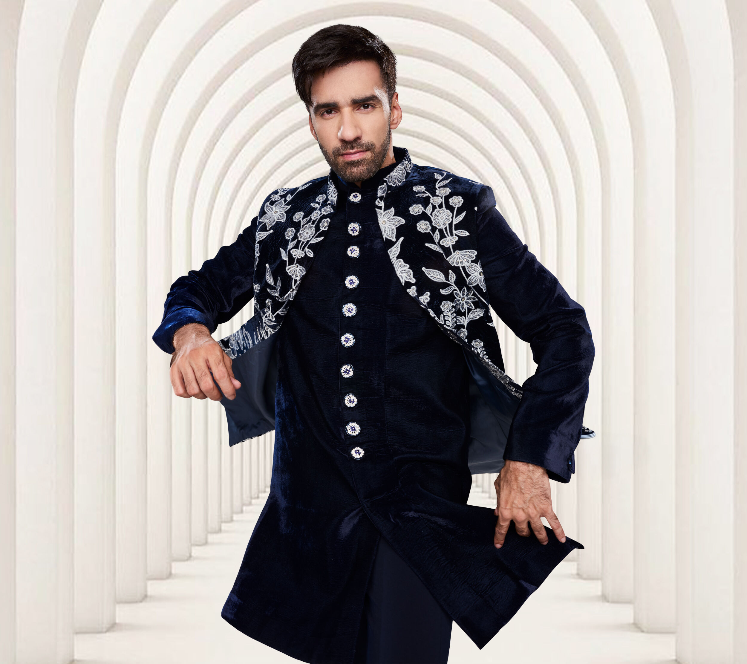A groom flaunting his indo western wedding outfit