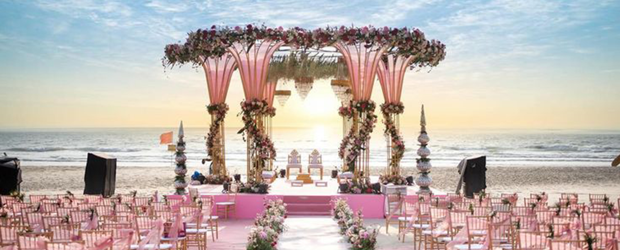 A beautifull wedding floor decorated with pink theme designed flowers and chairs with beach on bacground. A beautifull wedding floor decorated with pink theme designed flowers and chairs with beach on bacground.