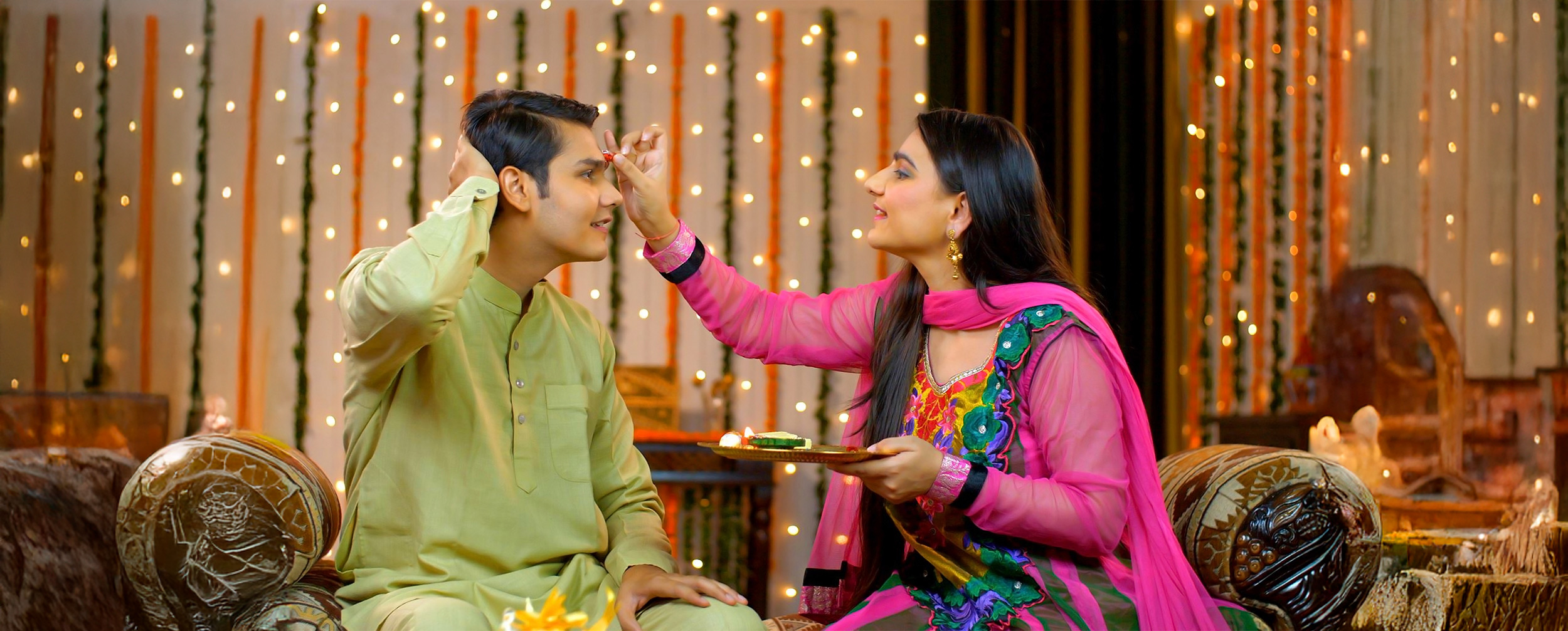 Sister applying tika on brothers forehead to celebrating the sibling bond for Raksha Bandhan festival Sister applying tika on brothers forehead to celebrating the sibling bond for Raksha Bandhan festival