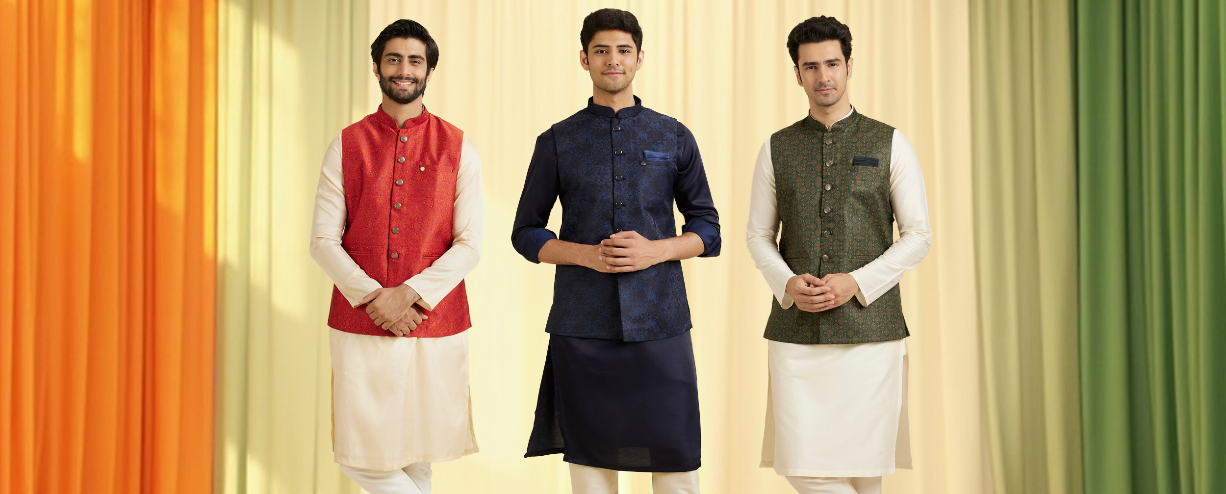 Three men wearing traditional Nehru jackets in red, navy blue, and green, styled over cream and navy kurta-pajama sets, posing against a tricolor-themed backdrop. Three men wearing traditional Nehru jackets in red, navy blue, and green, styled over cream and navy kurta-pajama sets, posing against a tricolor-themed backdrop.