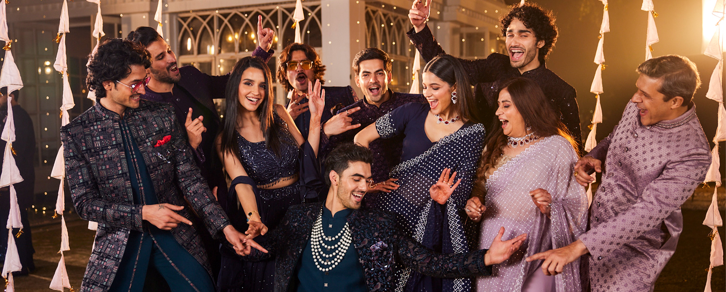 Groom dancing with friends during a lively sangeet performance Groom dancing with friends during a lively sangeet performance