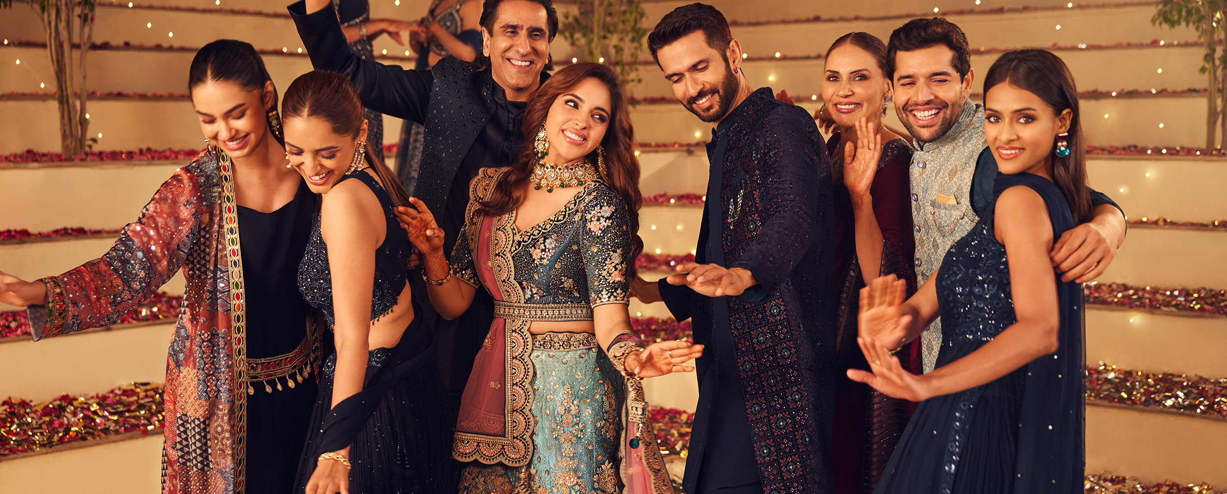 Groom and bride with groomsmen and bridesmaid wearing lehengas and sherwanis for wedding event Groom and bride with groomsmen and bridesmaid wearing lehengas and sherwanis for wedding event