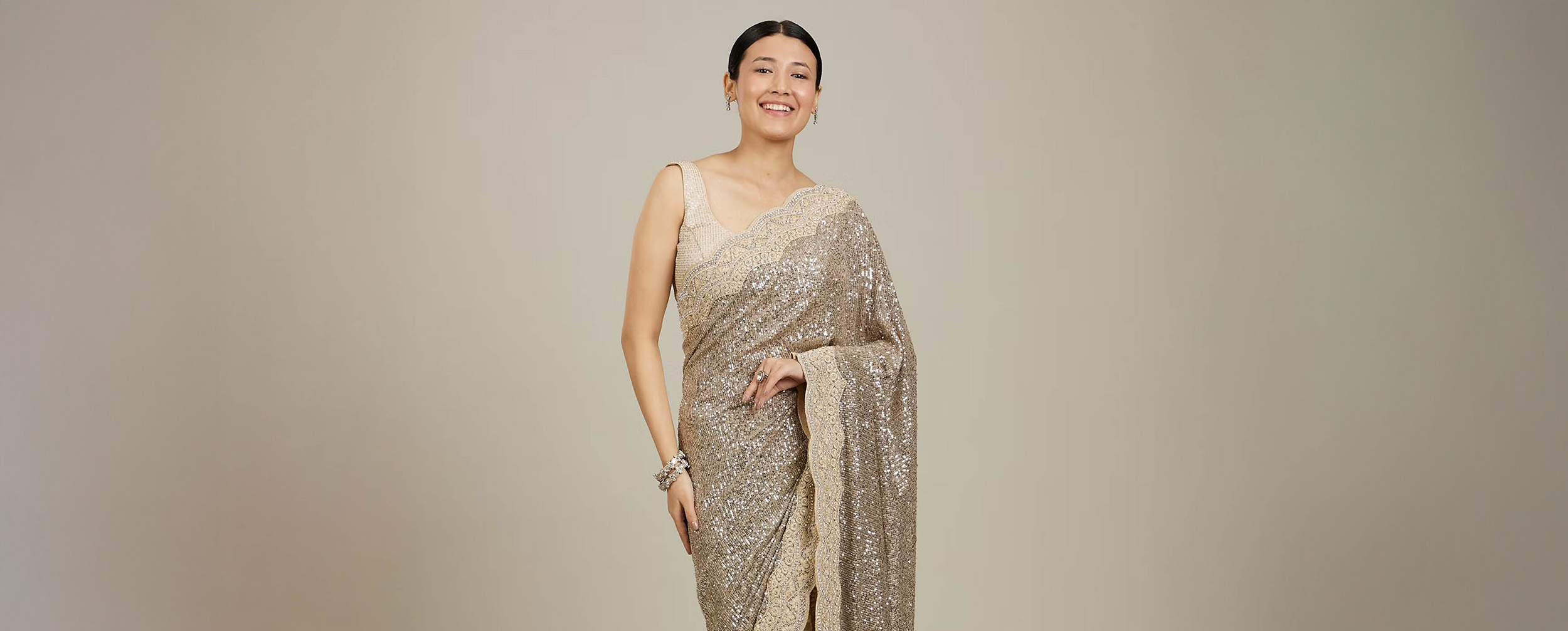 women wearing golden Net Saree with a Spaghetti-Strap Blouse women wearing golden Net Saree with a Spaghetti-Strap Blouse