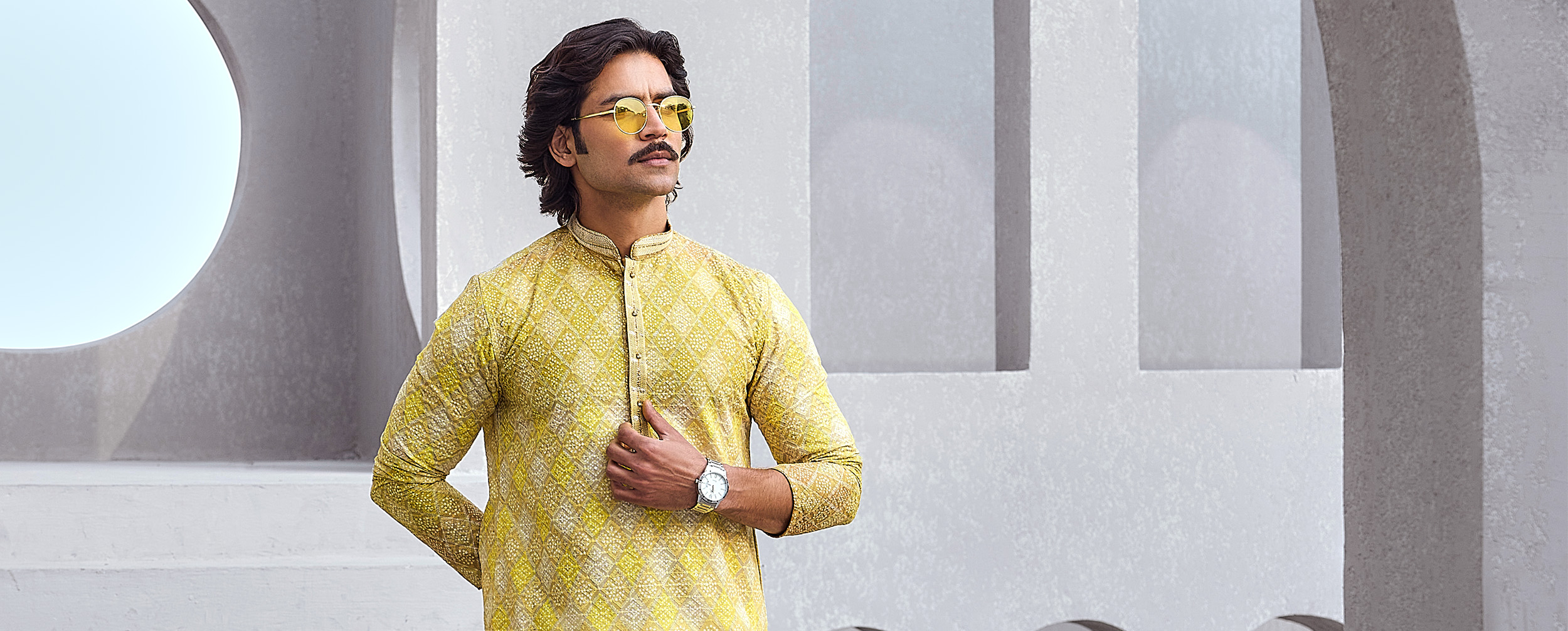 A man wearing a yellow Printed Kurta Set for engagement ceremony A man wearing a yellow Printed Kurta Set for engagement ceremony