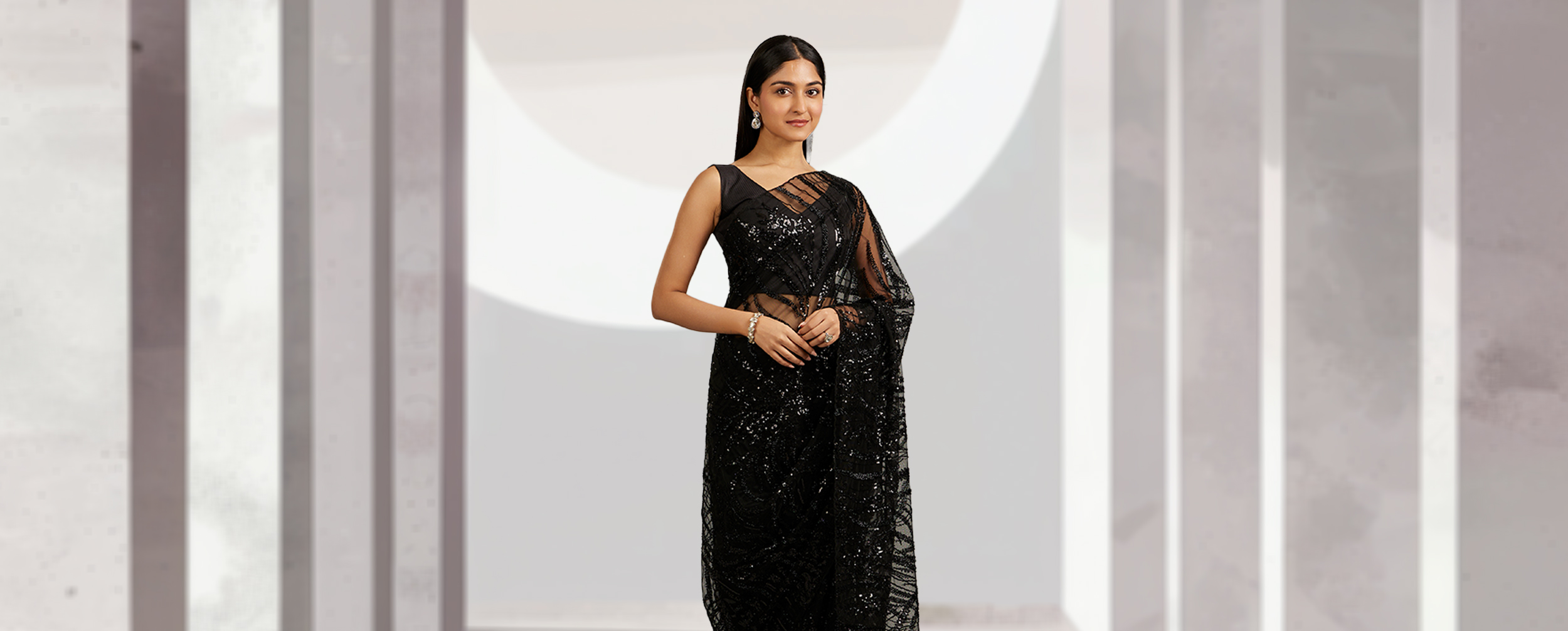 A beautiful woman in a black net saree A beautiful woman in a black net saree