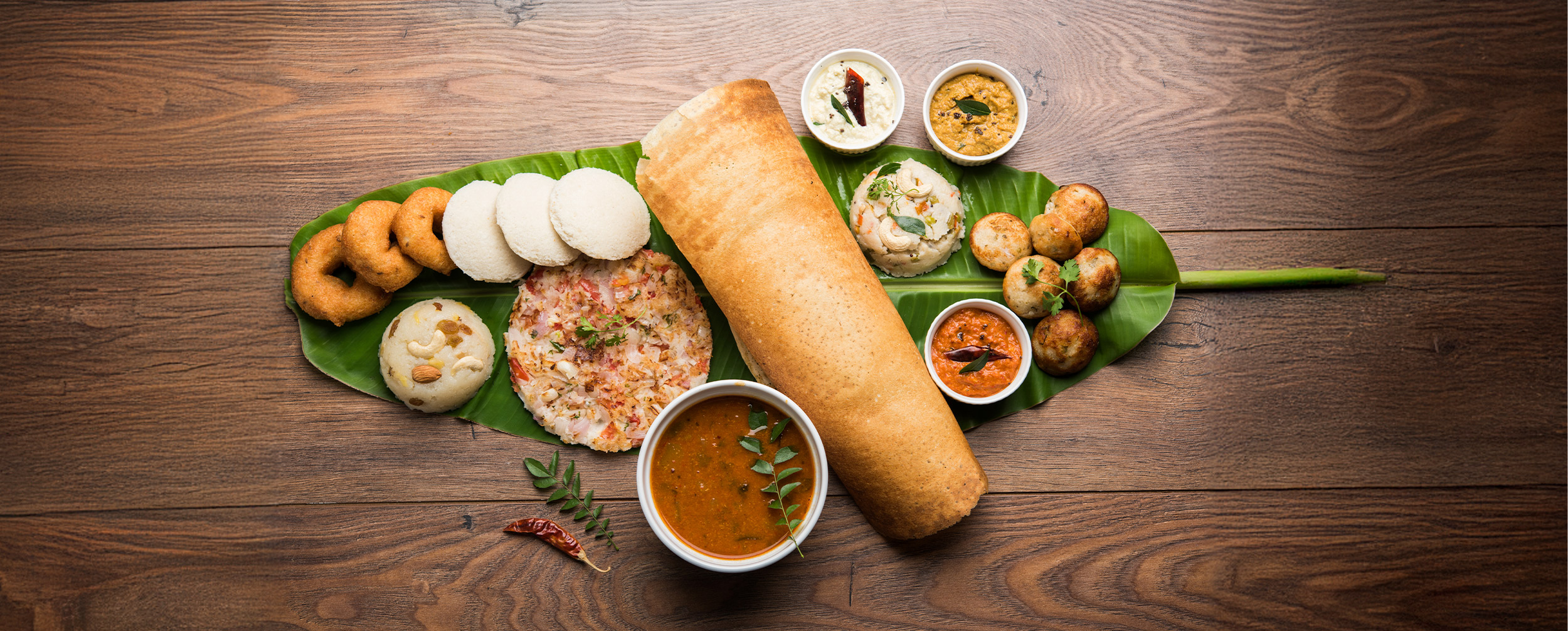 Sadya meal served on a banana leaf. Sadya meal served on a banana leaf.