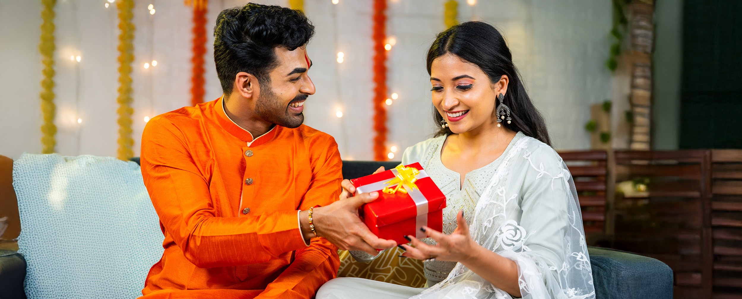 Brother giving gift box to his sister on raksha bandhan Brother giving gift box to his sister on raksha bandhan