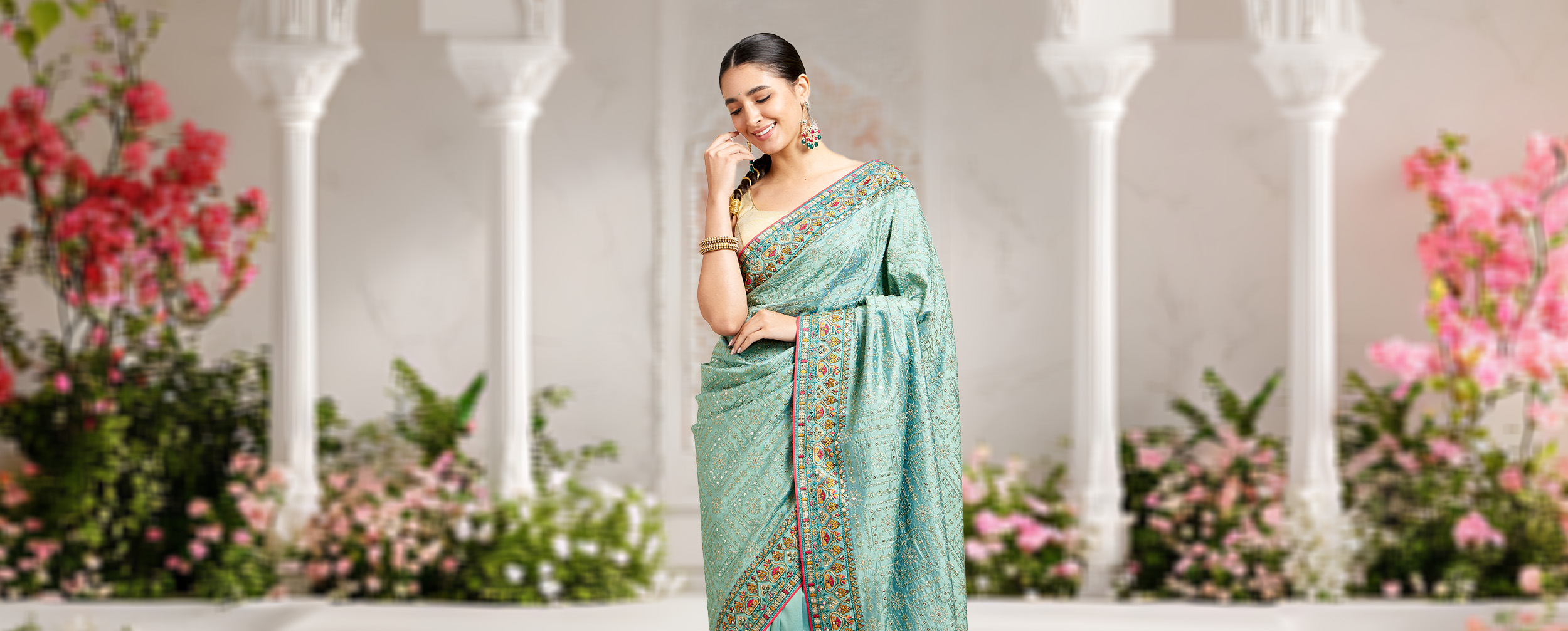 Woman wearing a beautiful green mirror work saree Woman wearing a beautiful green mirror work saree