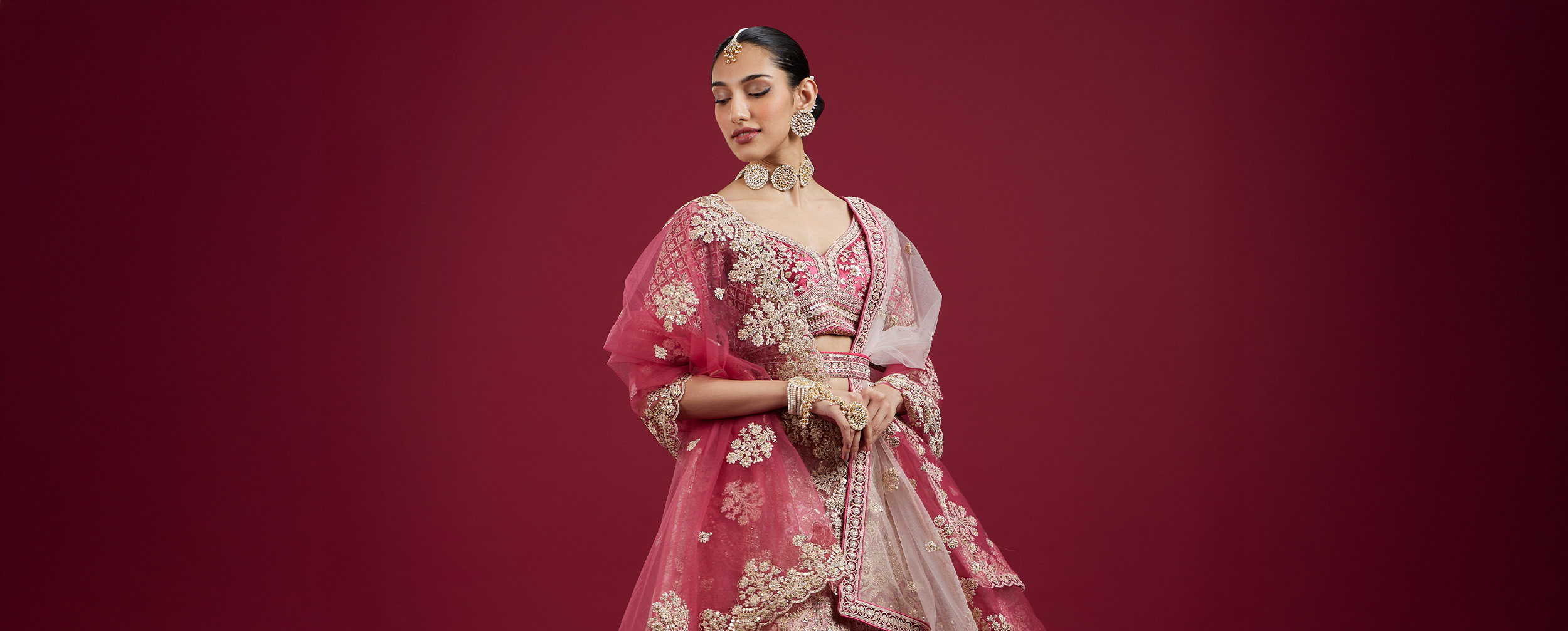 A beautiful bride in a pink lehenga with matching jwellary set