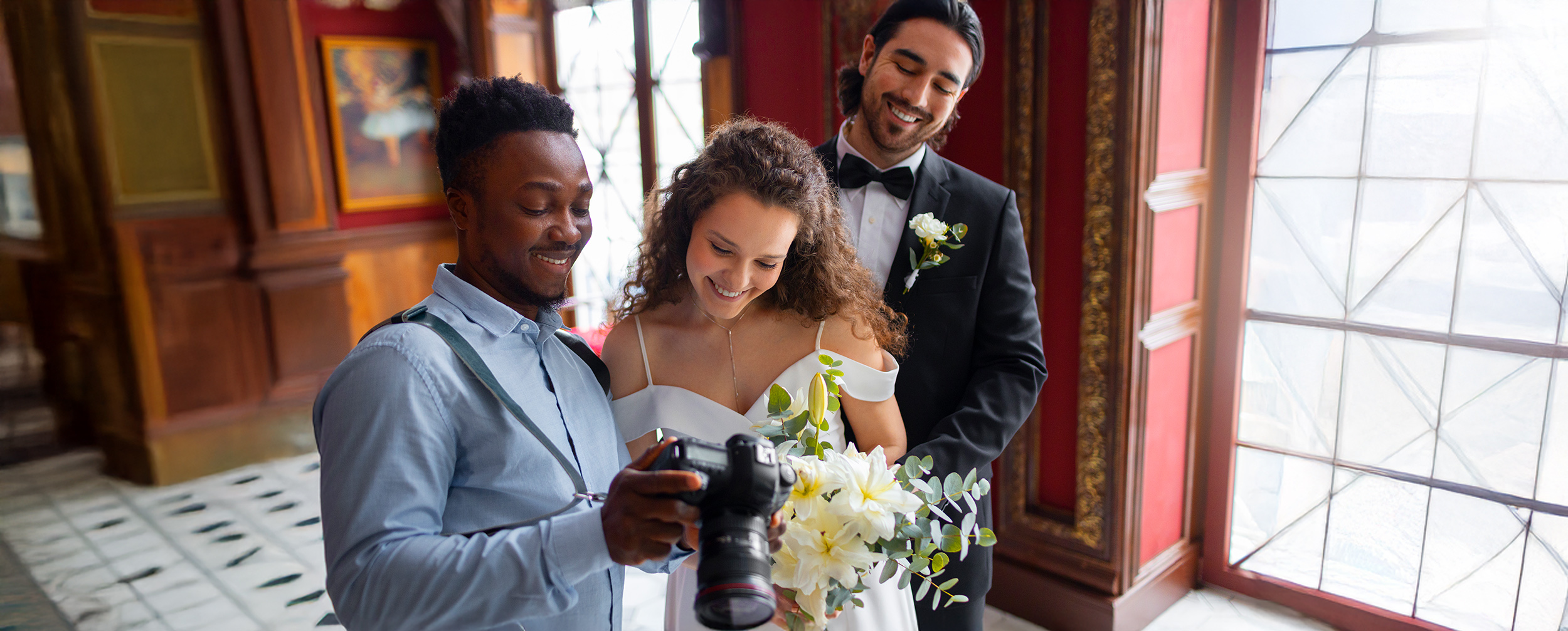 Wedding photographer showing photos to a couple during a wedding photoshoot in India.