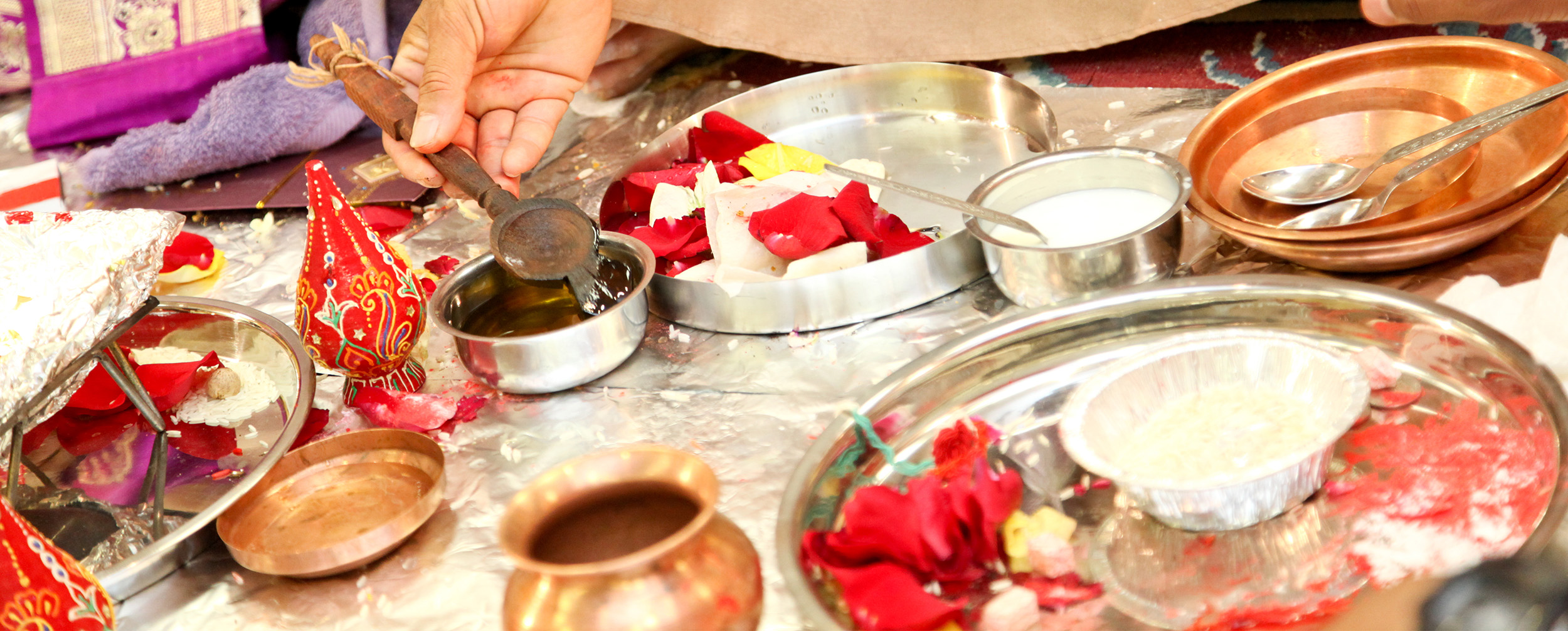 Traditional wedding pooja setup with a pandit performing rituals Traditional wedding pooja setup with a pandit performing rituals