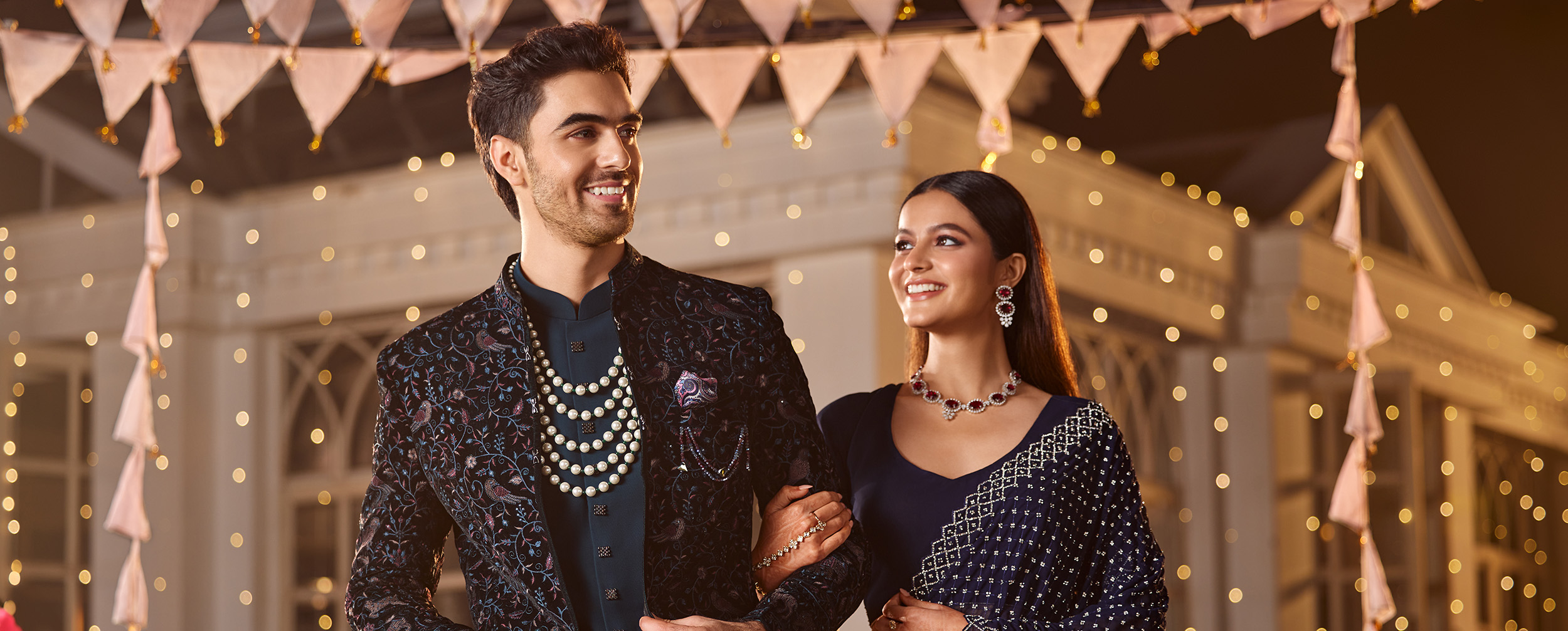 Bride in Purple patterned lehenga and groom wearing purple printed kurta jacket set Bride in Purple patterned lehenga and groom wearing purple printed kurta jacket set
