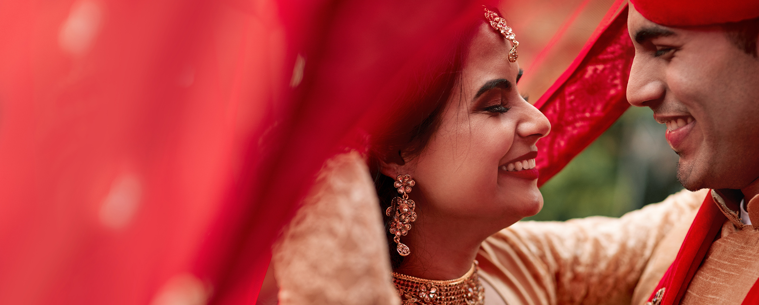Bride walking under a personalized bridal entry chadar at wedding Bride walking under a personalized bridal entry chadar at wedding