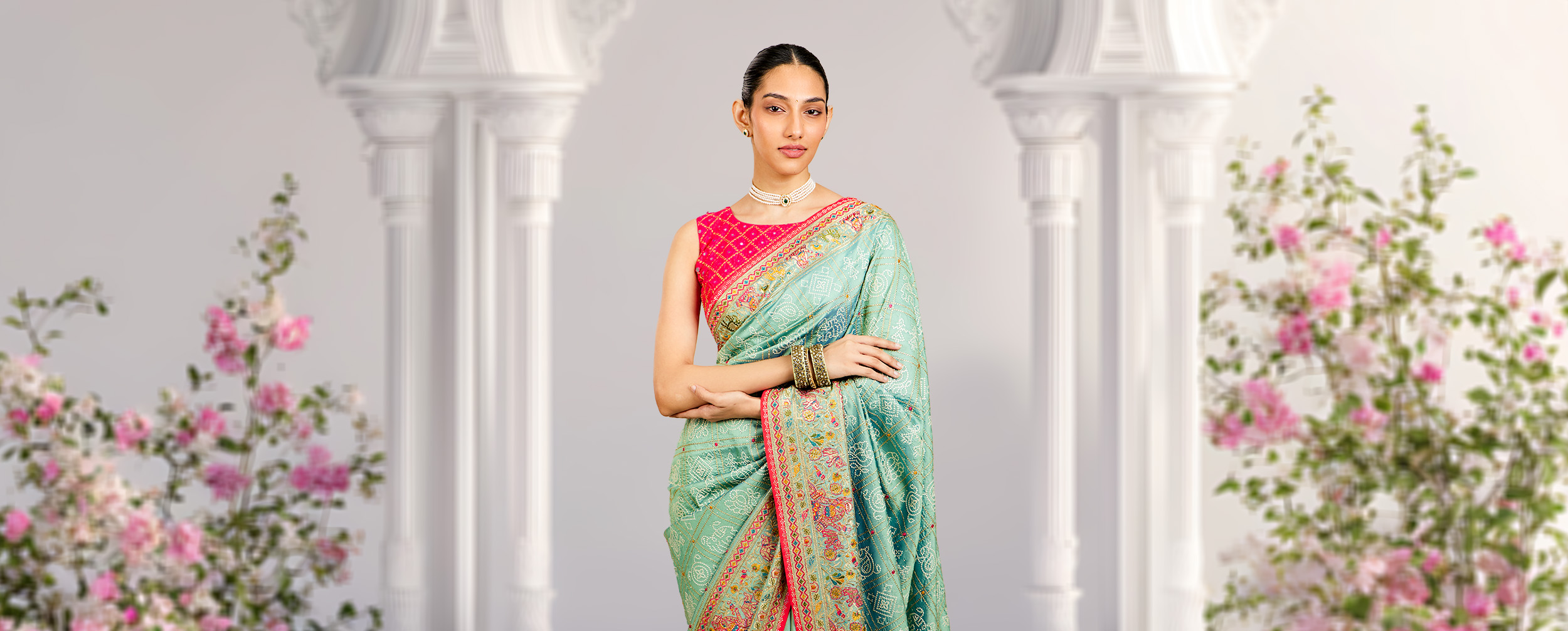 A lady wearing a floral pattern saree A lady wearing a floral pattern saree
