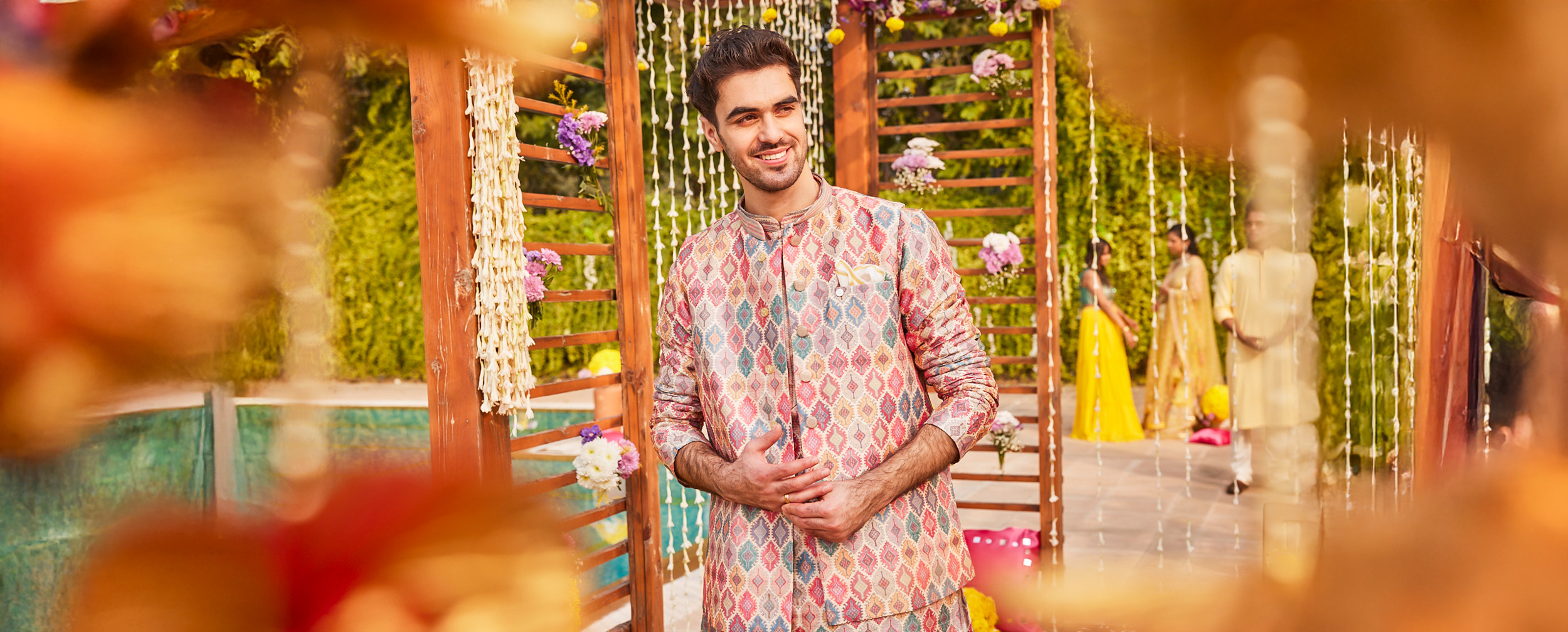 Man wearing a printed kurta for a photoshoot at a destination wedding Man wearing a printed kurta for a photoshoot at a destination wedding