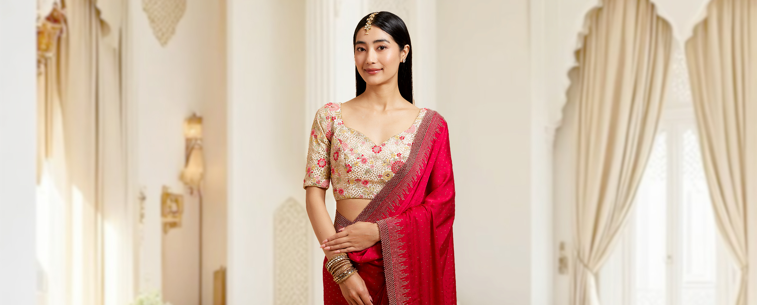 A women wearing beautifull designer blouse on red saree