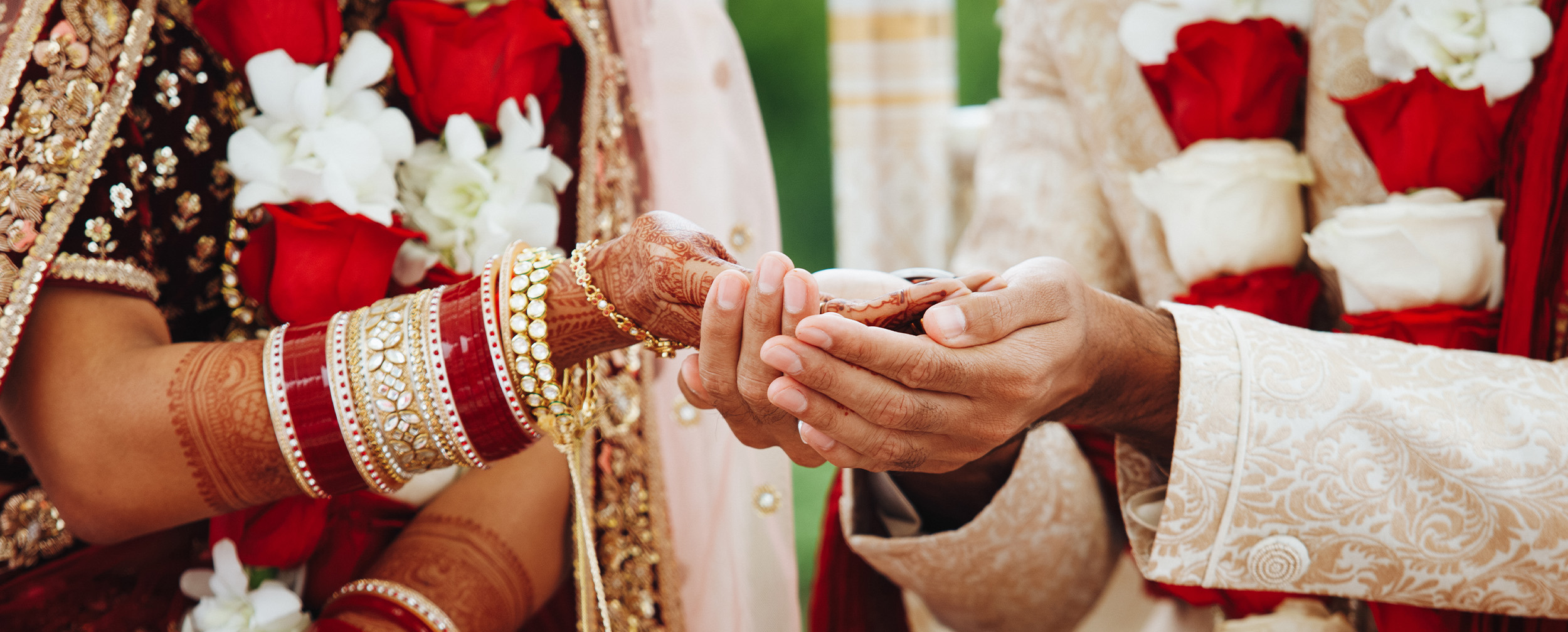 Blending rituals in an intercultural wedding, a grrom holding brides hand Blending rituals in an intercultural wedding, a grrom holding brides hand