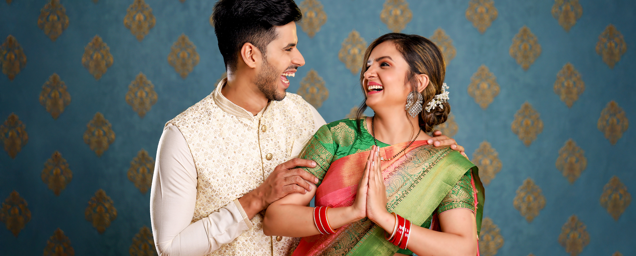 Happy couple celebrating Karwa Chauth in traditional attire with love and laughter