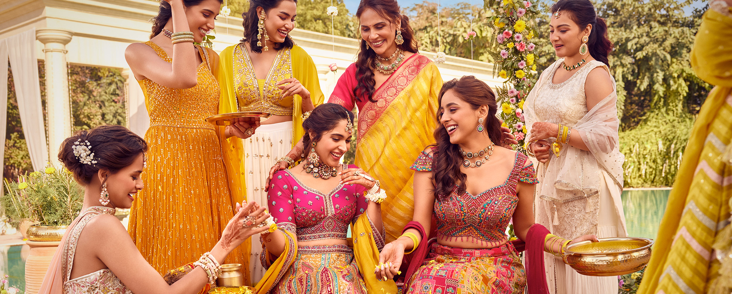 Bride and her mother with bridesmaid wearing colourful lehengas for wedding Bride and her mother with bridesmaid wearing colourful lehengas for wedding