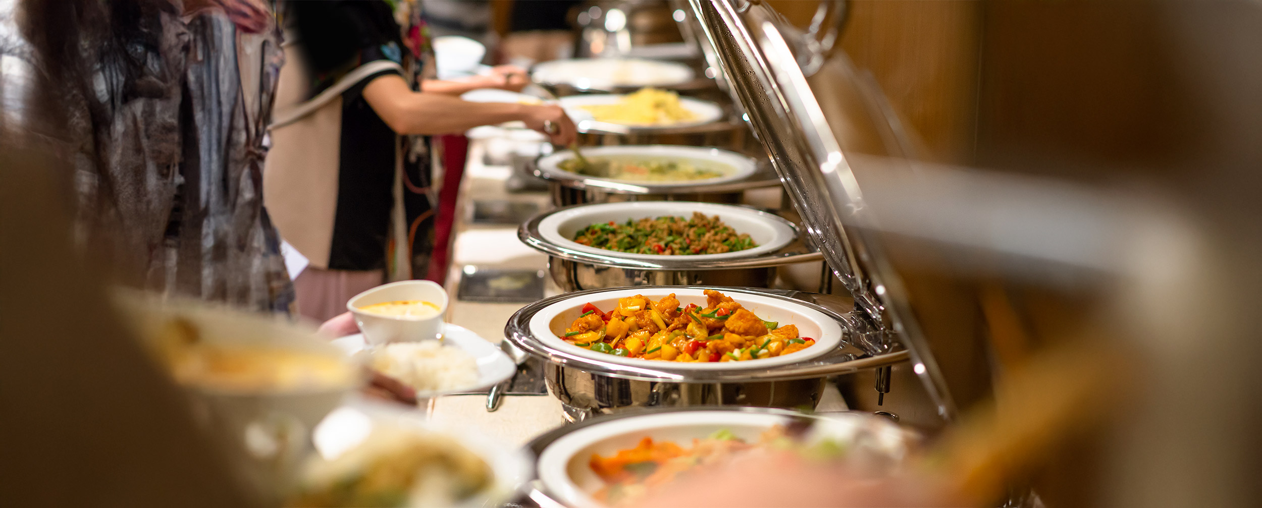Indian wedding buffet setup with a variety of colorful vegetarian dishes served in stainless steel chafing dishes. Indian wedding buffet setup with a variety of colorful vegetarian dishes served in stainless steel chafing dishes.
