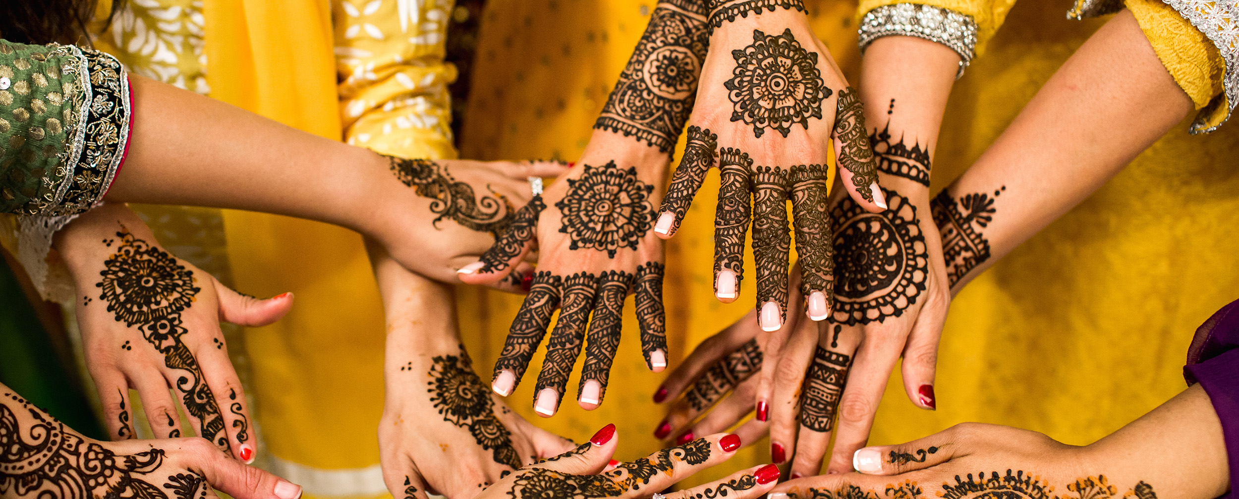 Bride and her friends showcasing intricate mehendi designs at a wedding celebration. Bride and her friends showcasing intricate mehendi designs at a wedding celebration.