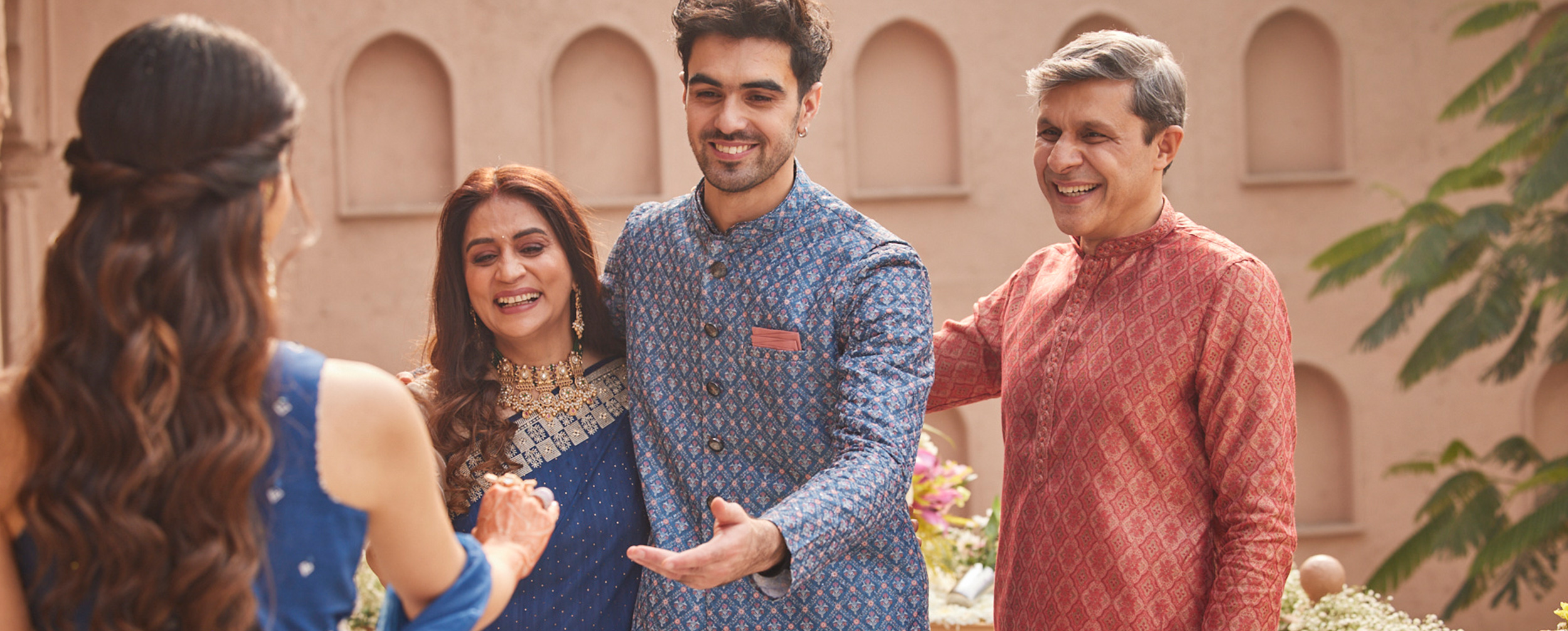 Family enjoying in traditional attire at the beginning of a Sikh Roka pre-wedding ceremony.