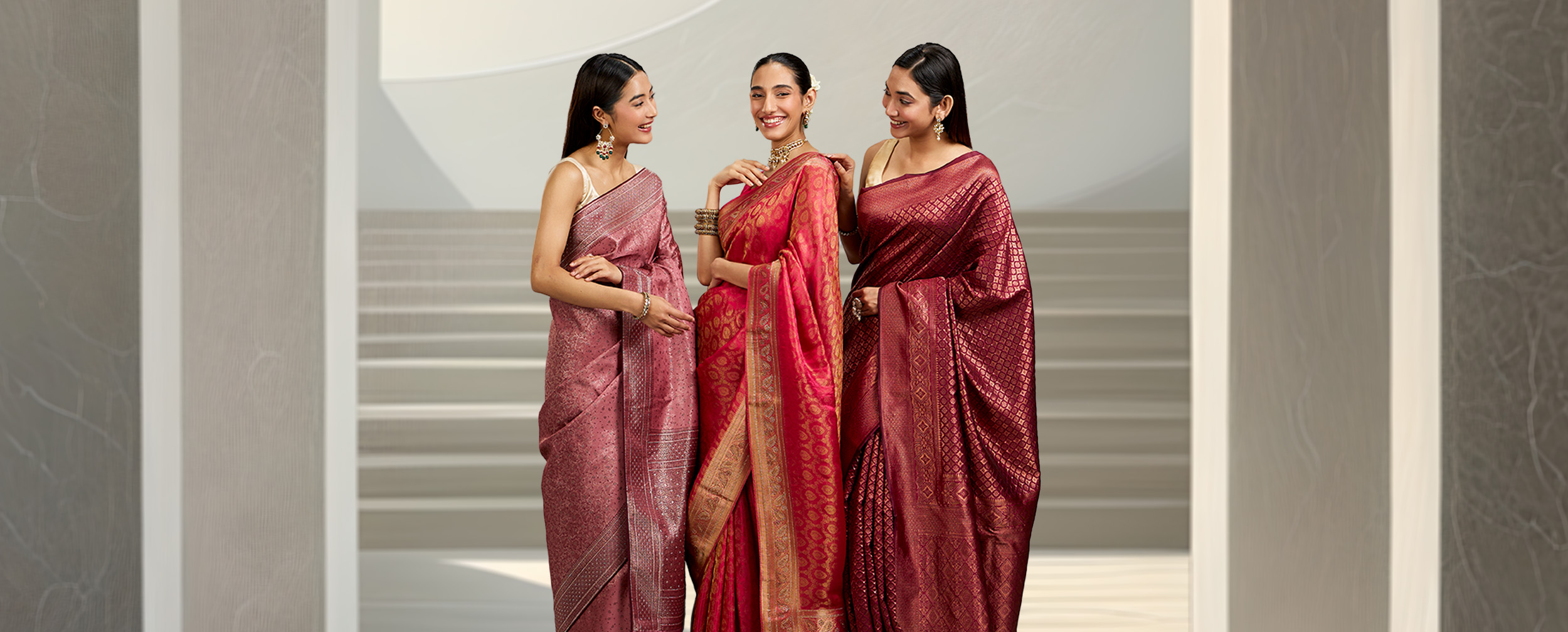 Elegant women dressed in stunning designer red, pink, and brown sarees, perfect for any occasion. Elegant women dressed in stunning designer red, pink, and brown sarees, perfect for any occasion.