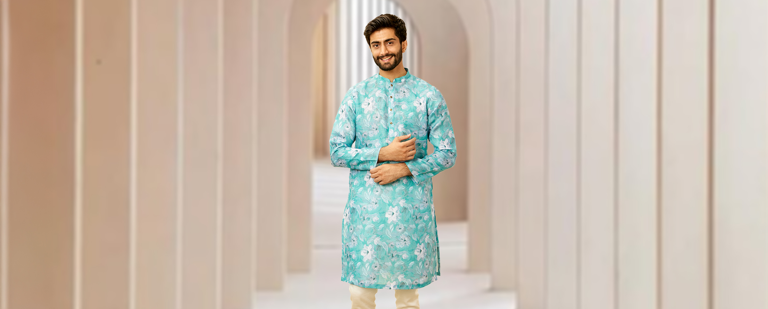 A men wearing sky blue formal kurta with flowers on it A men wearing sky blue formal kurta with flowers on it