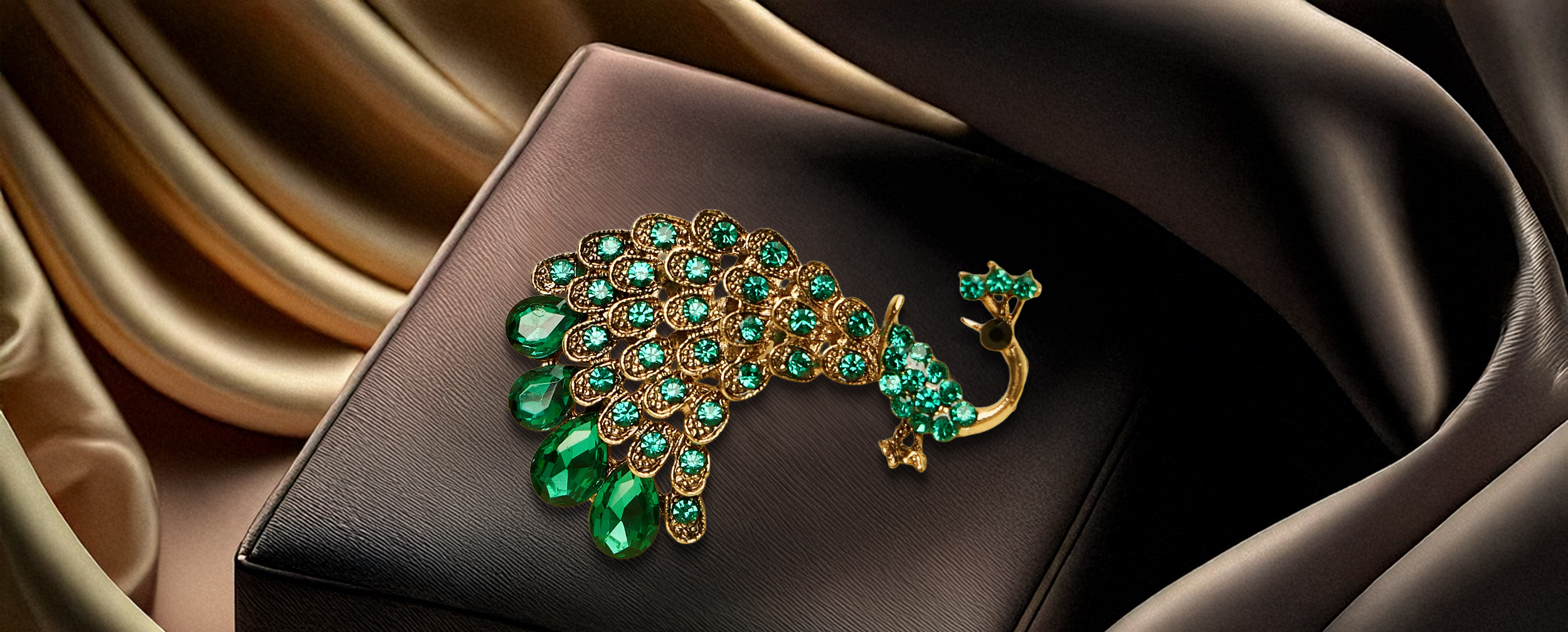 Luxurious peacock-shaped brooch with green emerald and rhinestone detailing, styled on a black suit lapel.