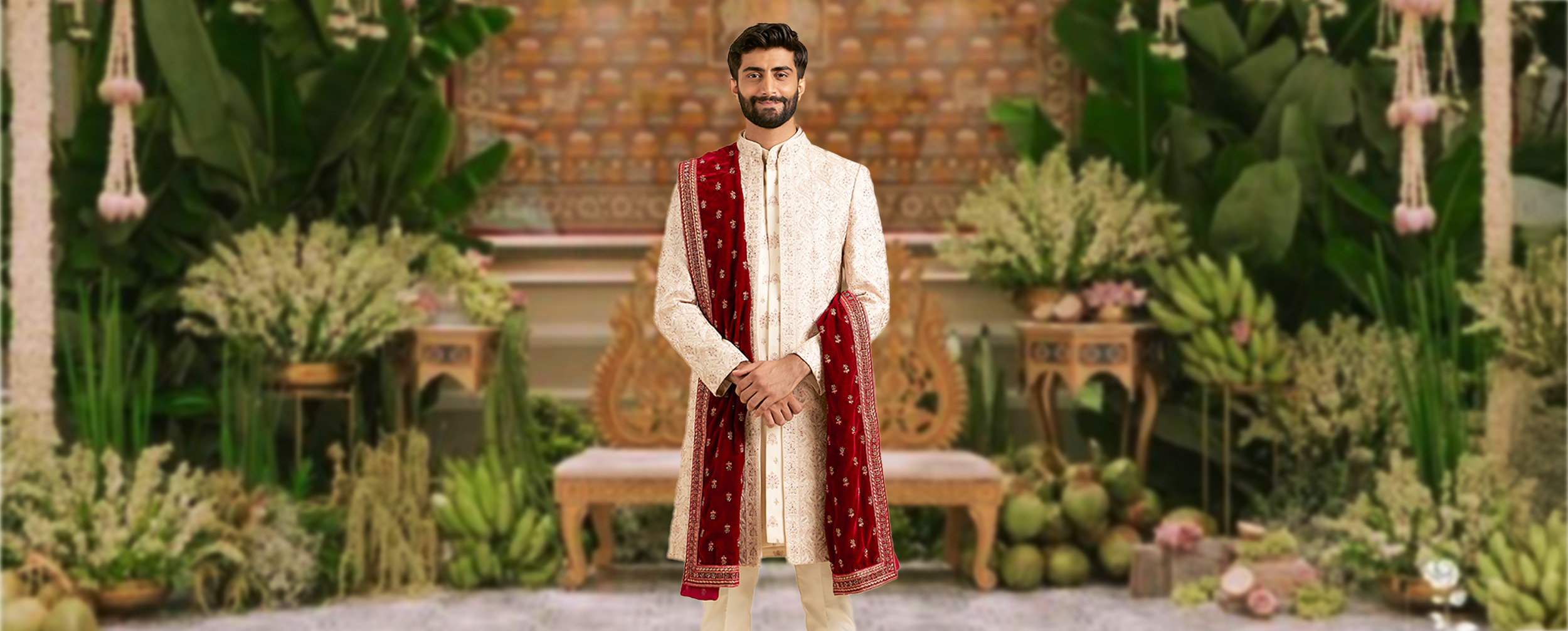 A groom wearing cream colour sherani with red dupatta A groom wearing cream colour sherani with red dupatta