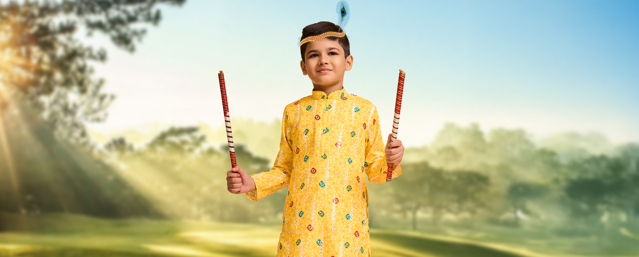 Young boy dressed as Lord Krishna in a yellow kurta for Janmashtami, holding dandiya sticks and wearing a peacock feather headband. Young boy dressed as Lord Krishna in a yellow kurta for Janmashtami, holding dandiya sticks and wearing a peacock feather headband.