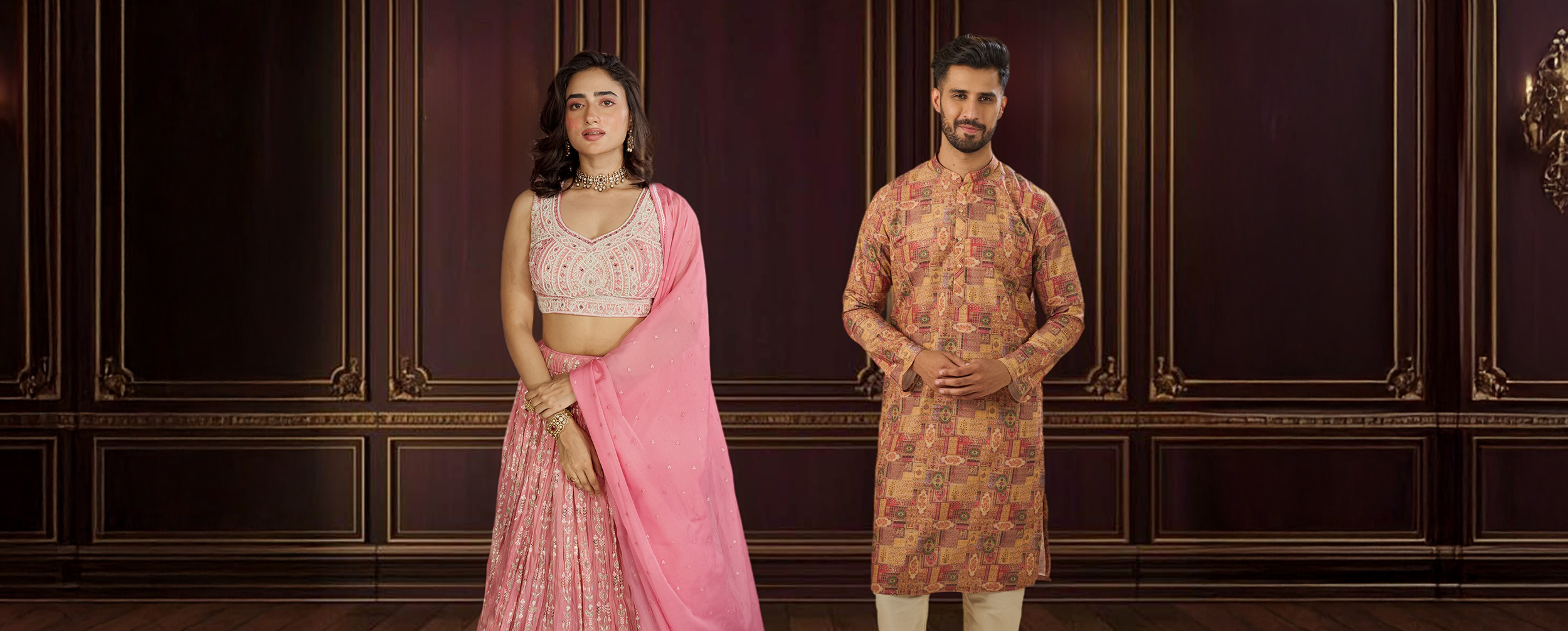 A happy couple in traditional Navratri outfits, featuring a woman in a pink lehenga and a man in a patterned kurta. A happy couple in traditional Navratri outfits, featuring a woman in a pink lehenga and a man in a patterned kurta.