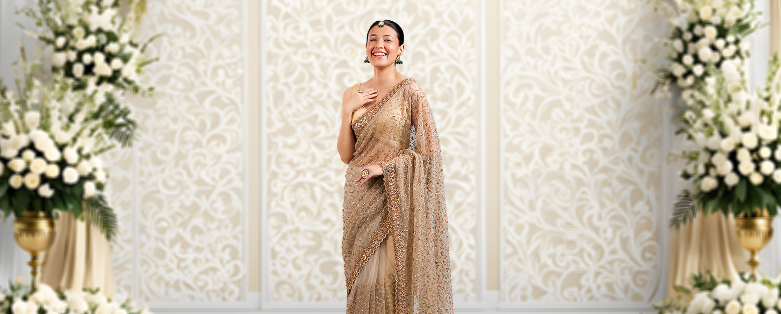 Woman wearing a beautifull golden beige saree Woman wearing a beautifull golden beige saree