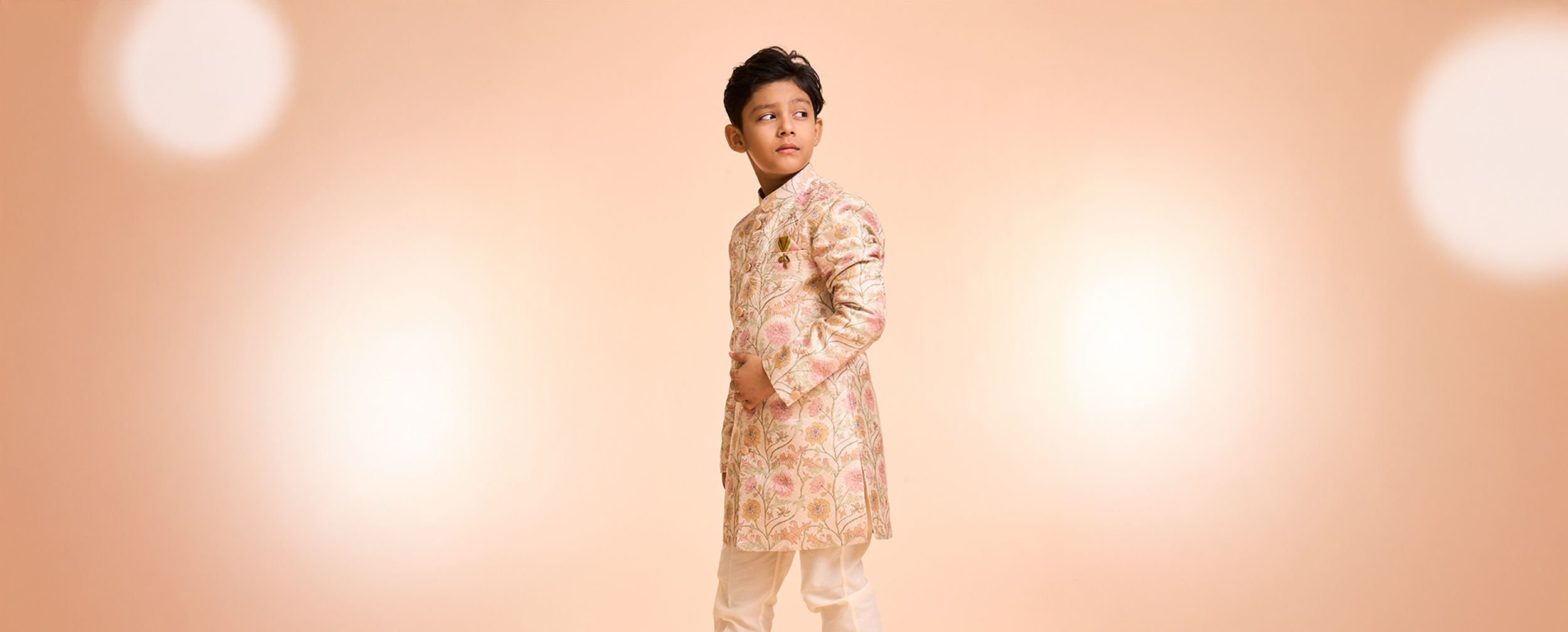 Boy wearing stylish indo western sherwani for wedding celebration Boy wearing stylish indo western sherwani for wedding celebration